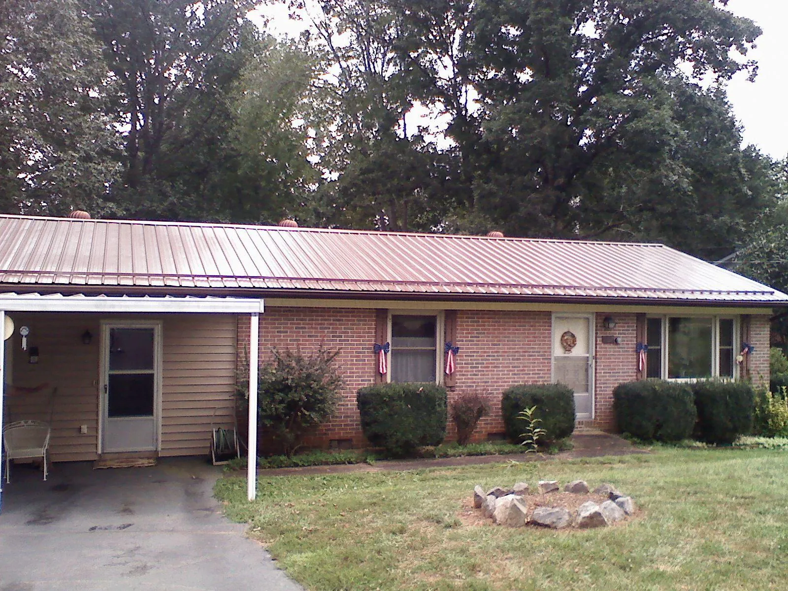 Bronze metal roof and carport on a brick ranch home — Roof Repair work by our crew in Othello